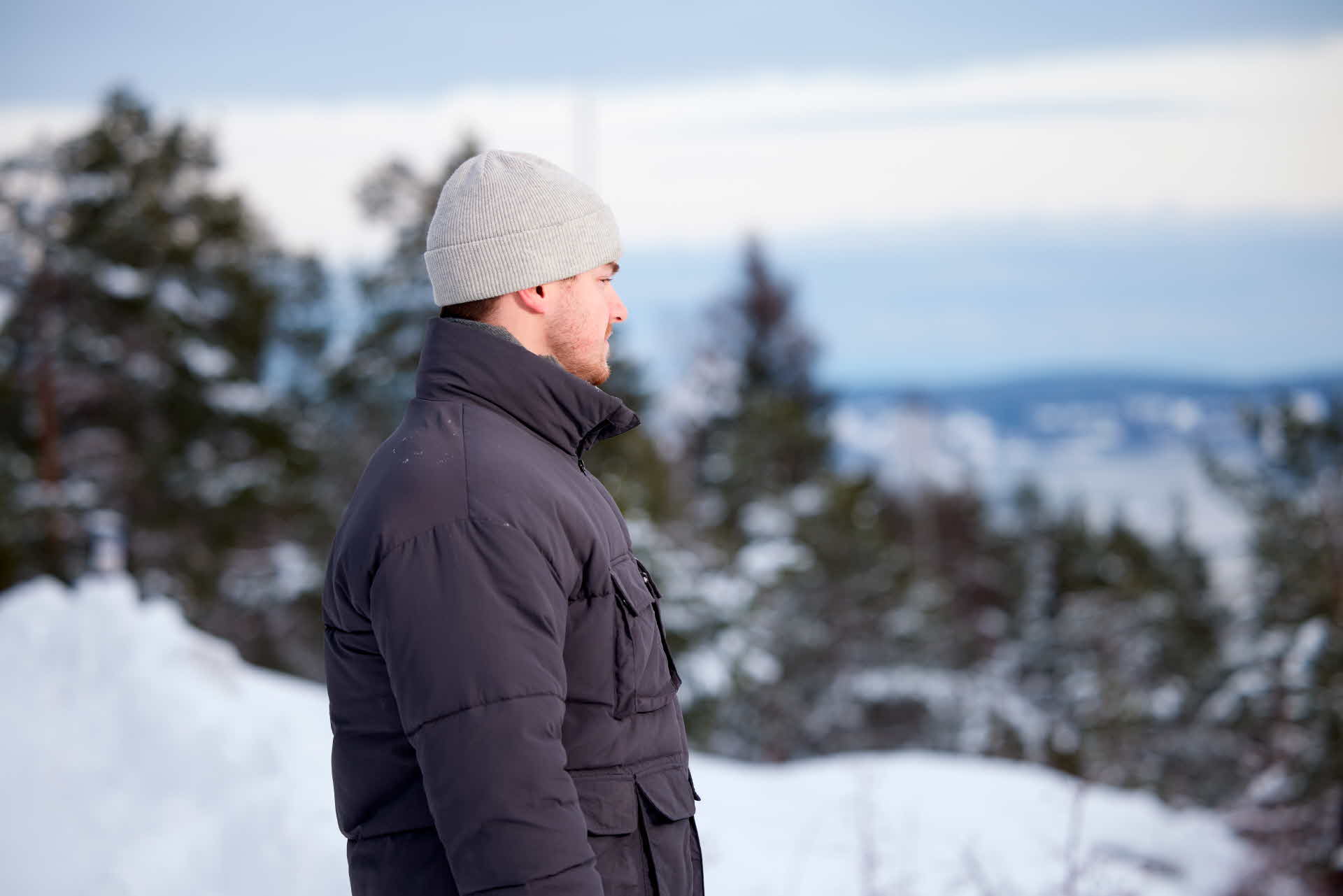 En medarbetare sedd från sidan med skog i bakgrunden.