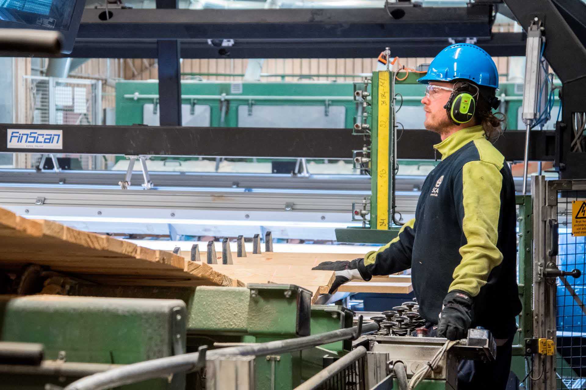 An employee engaged in operational work at one of our sawmills.