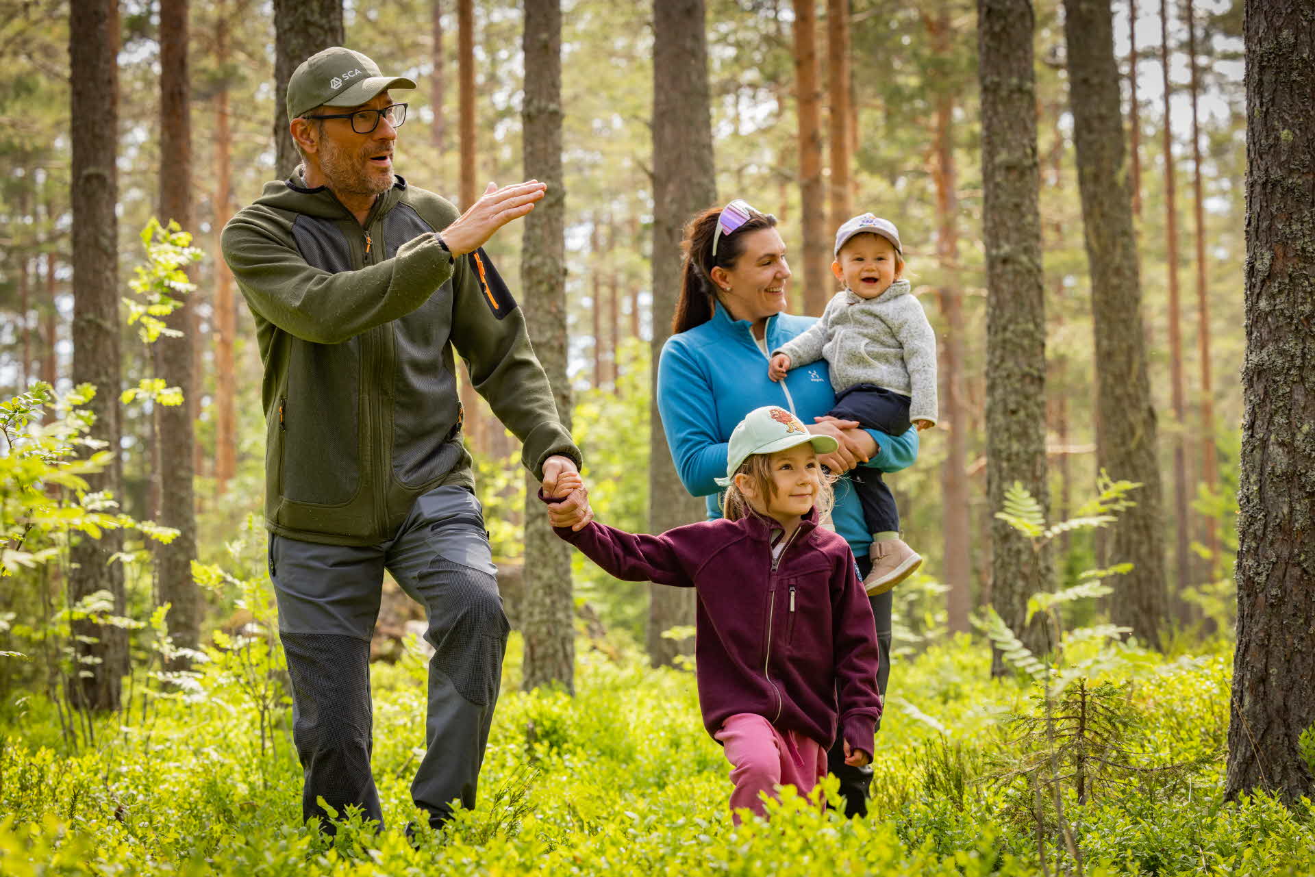 Familj vandrar i skogen