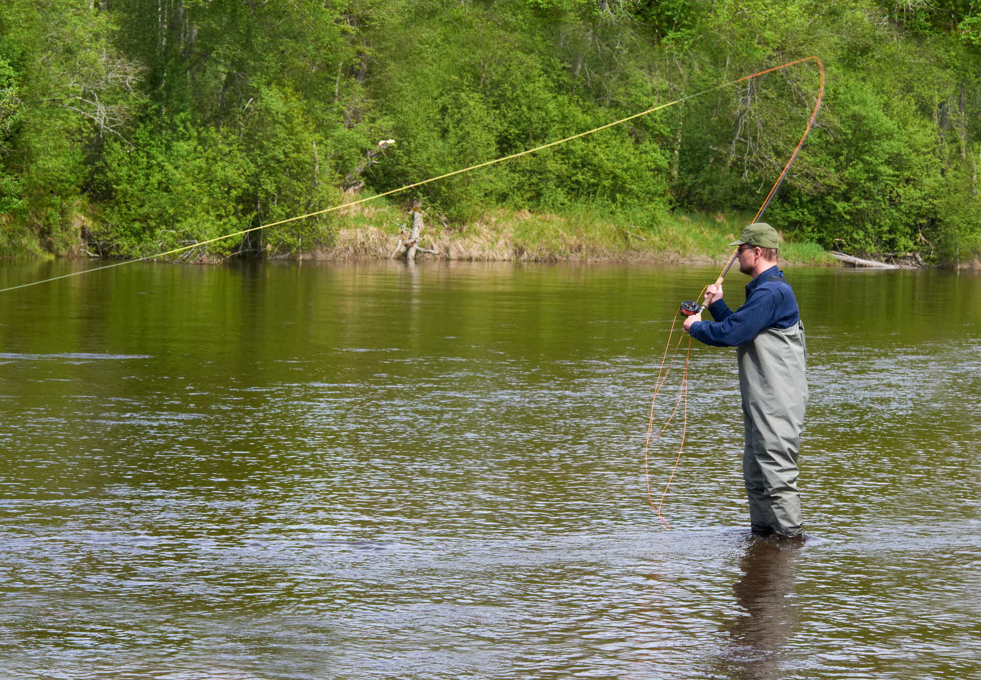 A m,am fishing in a stream