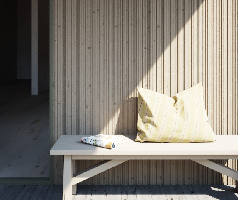 Närbild SCA Ursus monterad på ett hus. Framför fasaden står en bänk med en tidning och en gul kudde på.