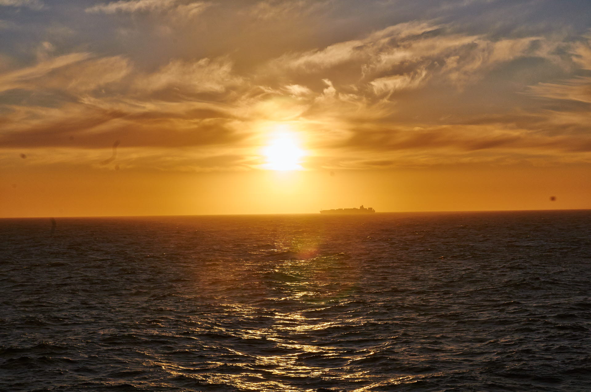 A cargo ship far away on the horizon