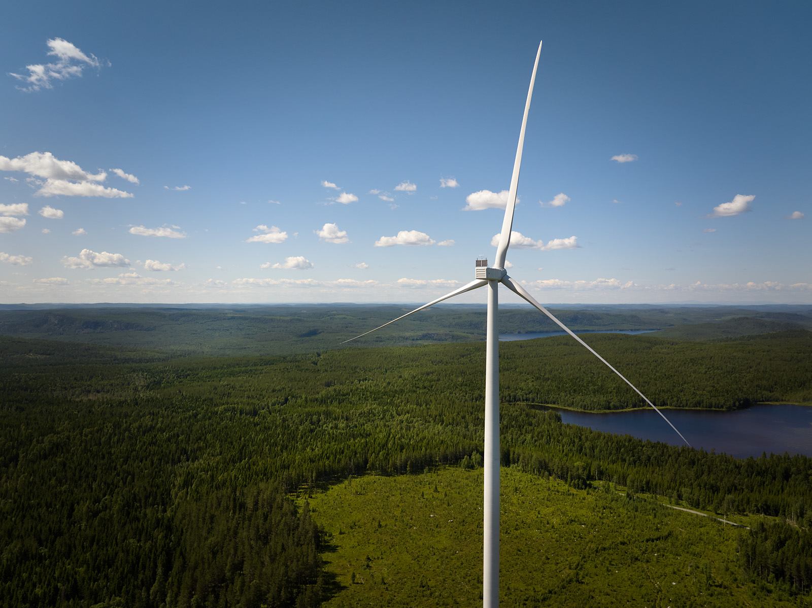 A wind turbine on a sunny summer day.