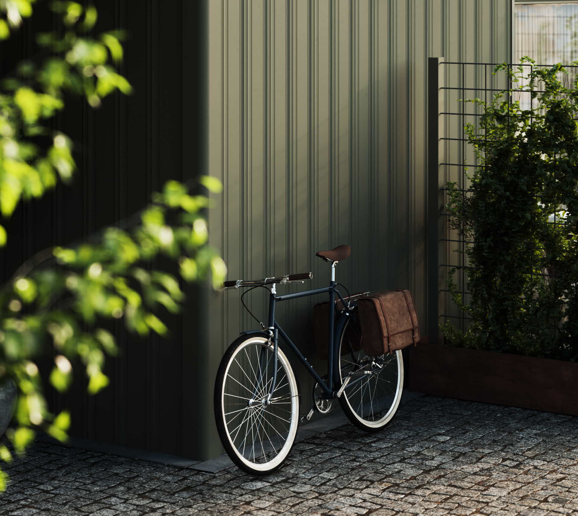 En cykel står parkerad mot en grönmålad ytterpanel.