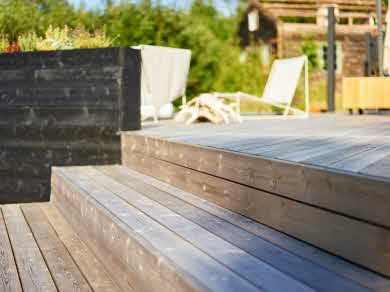 The impregnated decking forms a staircase leading up to a large decking.