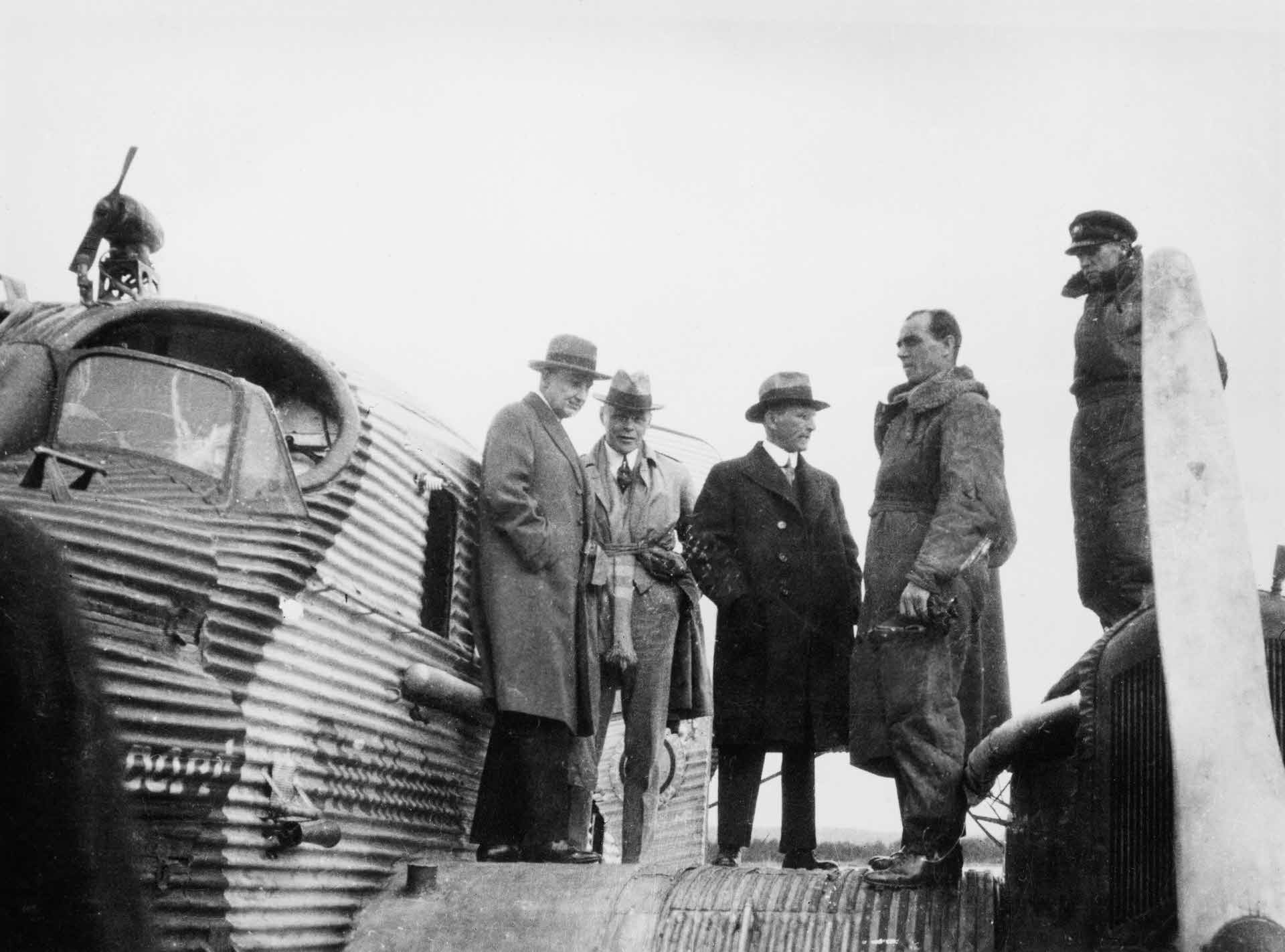 A portrait of Ivar Kreuger beside an airplane.